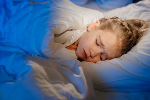 A,little,girl,naps,in,bed,in,her,room,,sees